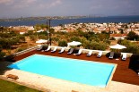 Xenon Estate luxurious villas panoramic view to the swimming pool as well as to the village of Spetses and the sea and mainland of Peloponnese
